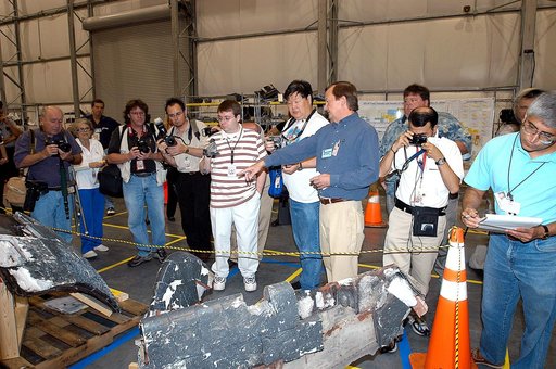 KENNEDY SPACE CENTER, FLA. - In the Columbia Debris Hangar,  Shuttle Launch Director Mike Leinbach  points to some of the debris as he explains to the media about activities that have taken place since the Columbia accident on Feb. 1, 2003.  STS-107 debris recovery and reconstruction operations are 