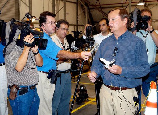 KENNEDY SPACE CENTER, FLA. - In the Columbia Debris Hangar,  Shuttle Launch Director Mike Leinbach  points to some of the debris as he explains to the media about activities that have taken place since the Columbia accident on Feb. 1, 2003.  STS-107 debris recovery and reconstruction operations are 