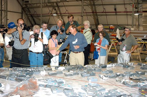 KENNEDY SPACE CENTER, FLA. -  In the Columbia Debris Hangar,  Shuttle Launch Director Mike Leinbach  points to some of the tiles recovered from the orbiter as he explains to the media about activities that have taken place since the Columbia accident on Feb. 1, 2003.  STS-107 debris recovery and rec