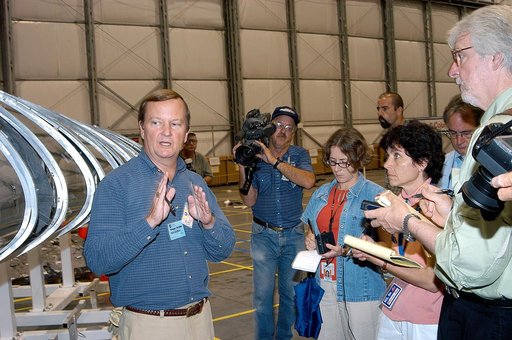 KENNEDY SPACE CENTER, FLA. -  In the Columbia Debris Hangar,  Shuttle Launch Director Mike Leinbach  (left) talks to the media about activities that have taken place since the Columbia accident on Feb. 1, 2003.  Behind him is a model of the left wing of the orbiter.  STS-107 debris recovery and reco