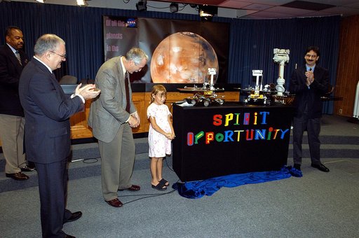 KENNEDY SPACE CENTER, FLA. -  Nine-year-old Sofi Collis unveils the names of the Mars Exploration Rovers  -- "Spirit" and "Opportunity" --  during a press conference.  Participating in the press conference are, from left, Dr. John Marburger, science advisor to the President and director of the Offic