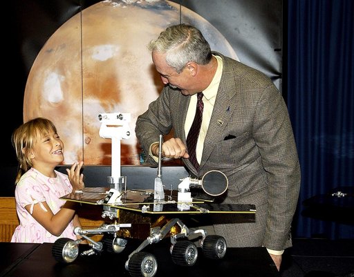 KENNEDY SPACE CENTER, FLA. -  Nine-year-old Sofi Collis (left) shares a light moment with NASA Administrator Sean O'Keefe at a press conference.   The Siberian-born Arizona resident wrote the winning entry in the Name the Rovers Contest sponsored by NASA and the Lego Co., a Denmark-based toymaker, w