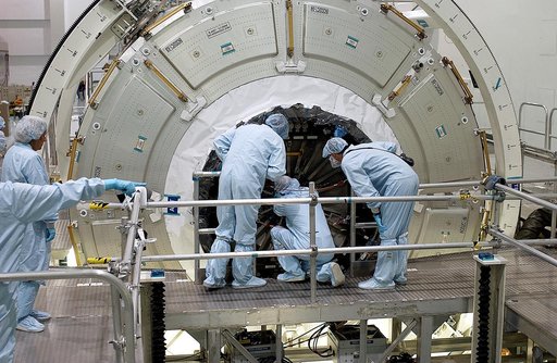 KENNEDY SPACE CENTER, FLA. -  Workers in the Space Station Processing Facility attempt to open the hatch on the Italian-built Node 2, a future element of the International Space Station.  Node 2 arrived at KSC June 1.  The second of three Station connecting modules, the module  attaches to the end o