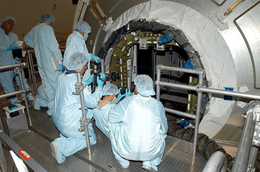 KENNEDY SPACE CENTER, FLA. -  Workers in the Space Station Processing Facility attempt to open the hatch on the Italian-built Node 2, a future element of the International Space Station.  Node 2 arrived at KSC June 1.  The second of three Station connecting modules, the module  attaches to the end o