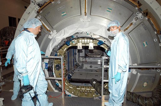 KENNEDY SPACE CENTER, FLA. -  Workers in the Space Station Processing Facility stand by after opening the hatch on the Italian-built Node 2, a future element of the International Space Station.  Node 2 arrived at KSC June 1.  The second of three Station connecting modules, the module  attaches to th