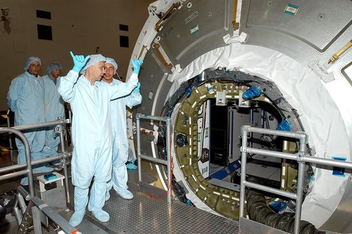 KENNEDY SPACE CENTER, FLA. -  In the Space Station Processing Facility, workers talk near the opened hatch of the Italian-built Node 2.  A future element of the International Space Station,  Node 2 arrived at KSC June 1.  The second of three Station connecting modules, Node 2 attaches to the end of 