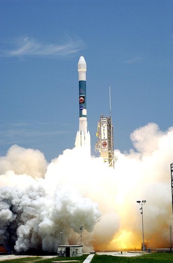 KENNEDY SPACE CENTER, FLA. -  With smoke and steam billowing beneath, the Delta II rocket with its Mars Exploration Rover (MER-A) payload leaps off the launch pad into the blue sky to begin its journey to Mars.  Liftoff occurred on time at 1:58 p.m. EDT from Launch Complex 17-A, Cape Canaveral Air F