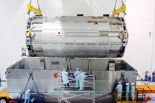 KENNEDY SPACE CENTER, FLA. -  In the Space Station Processing Facility, an overhead crane lifts the Japanese Experiment Module (JEM) pressure module out of the shipping canister to move it to a work stand.  A research laboratory, the pressurized module is the first element of the JEM, named "Kibo" (