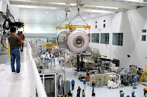 KENNEDY SPACE CENTER, FLA. -   Removed from its shipping canister, the Japanese Experiment Module (JEM) pressure module is moved across the floor of the Space Station Processing Facility to a work stand.  A research laboratory, the pressurized module is the first element of the JEM, named "Kibo" (Ho