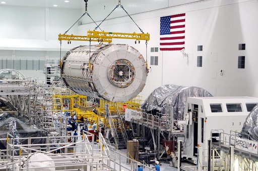 KENNEDY SPACE CENTER, FLA. -  The Japanese Experiment Module (JEM) pressure module is moved past other ISS elements in the Space Station Processing Facility to a work stand.  A research laboratory, the pressurized module is the first element of the JEM, named "Kibo" (Hope), to be delivered to KSC.  
