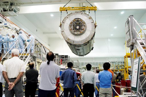 KENNEDY SPACE CENTER, FLA. -  In the Space Station Processing Facility, an overhead crane moves the Japanese Experiment Module (JEM) pressure module past other ISS elements to a work stand.  A research laboratory, the pressurized module is the first element of the JEM, named "Kibo" (Hope), to be del