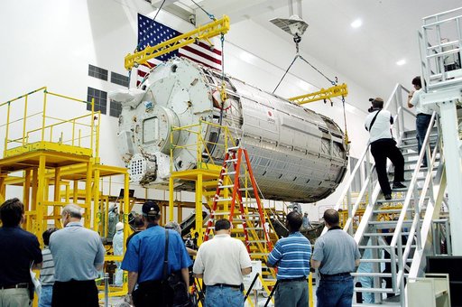 KENNEDY SPACE CENTER, FLA. - In the Space Station Processing Facility, the Japanese Experiment Module (JEM) pressure module is moved toward a work stand.  A research laboratory, the pressurized module is the first element of the JEM, named "Kibo" (Hope), to be delivered to KSC.   The National Space 