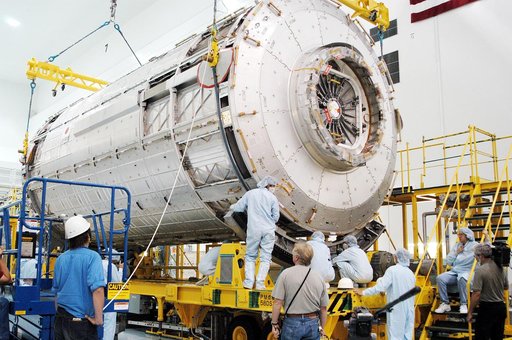 KENNEDY SPACE CENTER, FLA. - In the Space Station Processing Facility, the Japanese Experiment Module (JEM) pressure module is lowered onto a work stand.  A research laboratory, the pressurized module is the first element of the JEM, named "Kibo" (Hope), to be delivered to KSC.   The National Space 