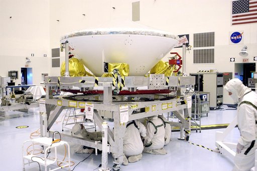 KENNEDY SPACE CENTER, FLA. - Workers in the Payload Hazardous Servicing Facility prepare Mars Exploration Rover 1 (MER-B) to be mated with the third stage of the Delta rocket that will launch it to Mars.  The second of twin rovers being sent to Mars, it is equipped with a robotic arm, a drilling too