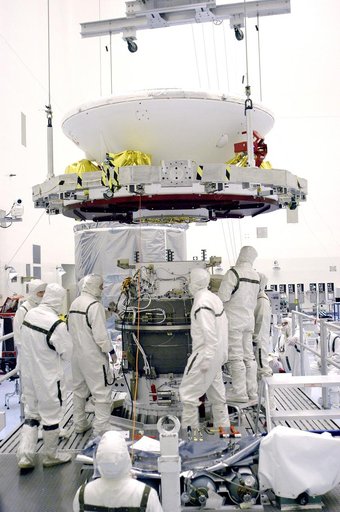 KENNEDY SPACE CENTER, FLA. - In the Payload Hazardous Servicing Facility, an overhead crane lowers Mars Exploration Rover 1 (MER-B) over the third stage of the Delta rocket.  The rover will be mated to the third stage for launch.  The second of twin rovers being sent to Mars, it is equipped with a r