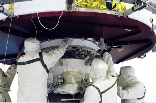 KENNEDY SPACE CENTER, FLA. - In the Payload Hazardous Servicing Facility, workers prepare to mate the Mars Exploration Rover 1 (MER-B) above with the third stage of the Delta rocket below.  The second of twin rovers being sent to Mars, it is equipped with a robotic arm, a drilling tool, three spectr