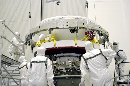KENNEDY SPACE CENTER, FLA. -In the Payload Hazardous Servicing Facility, workers prepare to mate the Mars Exploration Rover 1 (MER-B) above with the third stage of the Delta rocket below.  The second of twin rovers being sent to Mars, it is equipped with a robotic arm, a drilling tool, three spectro