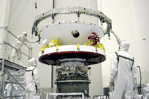 KENNEDY SPACE CENTER, FLA. -  In the Payload Hazardous Servicing Facility, workers check the connections after the Mars Exploration Rover 1 (MER-B) above was mated with the third stage of the Delta rocket below.  The second of twin rovers being sent to Mars, it is equipped with a robotic arm, a dril