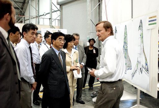 KENNEDY SPACE CENTER, FLA. -  Shuttle Launch Director Mike Leinbach (right) explains recovery and reconstruction efforts of Columbia to the Executive Director of NASDA Koji Yamamoto (center, foreground) and others visiting the Columbia Debris Hangar.   Mr. Yamamoto is at KSC for a welcome ceremony i