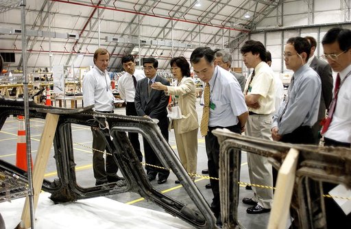 KENNEDY SPACE CENTER, FLA. -  Shuttle Launch Director Mike Leinbach (left) accompanies Executive Director of NASDA Koji Yamamoto (third from left) and others visiting the Columbia Debris Hangar.  Mr. Yamamoto is at KSC for a welcome ceremony involving the arrival of the newest Space Station module, 