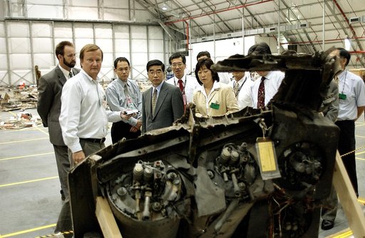 KENNEDY SPACE CENTER, FLA. -  Shuttle Launch Director Mike Leinbach (second from left) accompanies Executive Director of NASDA Koji Yamamoto (fourth from left) and others visiting the Columbia Debris Hangar.  Mr. Yamamoto is at KSC for a welcome ceremony involving the arrival of the newest Space Sta