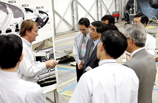 KENNEDY SPACE CENTER, FLA. -  Shuttle Launch Director Mike Leinbach (second from left) explains recovery and reconstruction efforts of Columbia to the Executive Director of NASDA Koji Yamamoto (fourth from left) and others visiting the Columbia Debris Hangar.   Mr. Yamamoto is at KSC for a welcome c