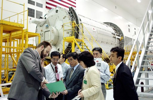 KENNEDY SPACE CENTER, FLA. -  In the Space Station Processing Facility, Executive Director of NASDA Koji Yamamoto (center) gets information about the facility while on a tour of KSC.  Behind the group is the Japanese Experiment Module (JEM)/pressurized module.  Mr. Yamamoto is at KSC for a welcome c