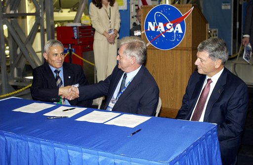 KENNEDY SPACE CENTER, FLA. - At ceremony highlighting the arrival of two major components of the International Space Station, Node 2 and the Japanese Experiment Module (JEM), ownership of Node 2 was officially transferred between the European Space Agency and NASA.  Shaking hands after the signing a