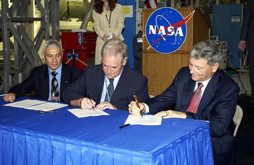 KENNEDY SPACE CENTER, FLA. - Alan Thirkettle (center), International Space Station Program manager for Node 2, European Space Agency (ESA); and NASA’s Michael C. Kostelnik (right), deputy associate administrator for International Space Station and Shuttle Programs, sign documents officially transfer