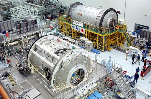 KENNEDY SPACE CENTER, FLA. -  International Space Station elements being processed for launch on upcoming Space Shuttle flights, including the U.S. Node 2 and the Japanese Experiment Module (JEM) pressurized module, line the walls of the high bay in the Space Station Processing Facility. NASA's Node