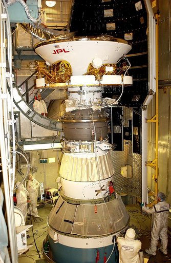 KENNEDY SPACE CENTER, FLA. - At Launch Complex 17-B, Cape Canaveral Air Force Station, workers prepare to install the spacecraft fairing around the Mars Exploration Rover-1 (MER-B). The second of twin rovers being sent to Mars, it is equipped with a robotic arm, a drilling tool, three spectrometers,