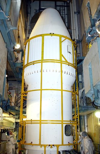 KENNEDY SPACE CENTER, FLA. - At Launch Complex 17-B, Cape Canaveral Air Force Station, workers complete the installation of the spacecraft fairing around the Mars Exploration Rover-1 (MER-B) for launch. The second of twin rovers being sent to Mars, it is equipped with a robotic arm, a drilling tool,