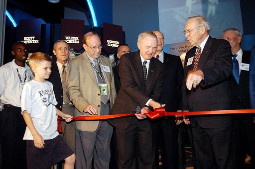 KENNEDY SPACE CENTER, FLA. -  Center Director and former astronaut Roy D. Bridges, Jr., (holding scissors) cuts the ribbon at a ceremony officially opening the U.S. Astronaut Hall of Fame as part of the Kennedy Space Center Visitor Complex.  Invited guests and dignitaries look on, such as former ast