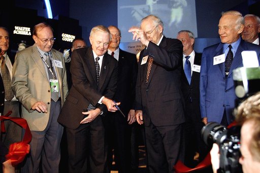 KENNEDY SPACE CENTER, FLA. -  Center Director and former astronaut Roy D. Bridges, Jr., (holding scissors) cuts the ribbon at a ceremony officially opening the U.S. Astronaut Hall of Fame as part of the Kennedy Space Center Visitor Complex.  Invited guests and dignitaries look on, such as former ast
