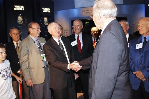 KENNEDY SPACE CENTER, FLA. -  Center Director and former astronaut Roy D. Bridges, Jr., (left) shakes hands with former astronaut James Lovell following a ribbon cutting ceremony officially opening the U.S. Astronaut Hall of Fame as part of the Kennedy Space Center Visitor Complex.  Invited guests a