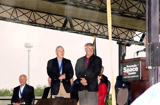 KENNEDY SPACE CENTER, FLA. -  At the KSC Visitor Complex, former astronaut Daniel Brandenstein (standing right) is presented to the audience at his induction ceremony into the U.S. Astronaut Hall of Fame. Also standing is former astronaut James A. Lovell.  Seated on the dais, from left, are former a