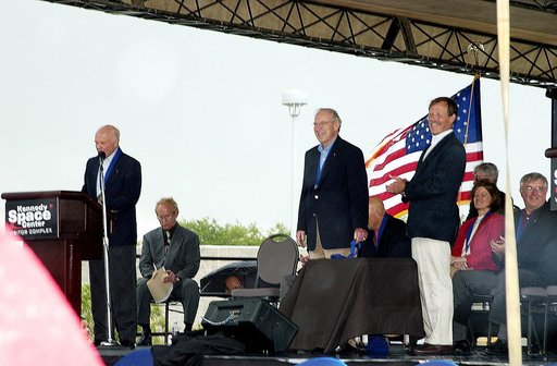 KENNEDY SPACE CENTER, FLA. -  At the KSC Visitor Complex, former astronaut John H. Glenn (at podium) presents former astronaut Robert "Hoot" Gibson (standing right) at his induction ceremony into the U.S. Astronaut Hall of Fame. Also standing is former astronaut James A. Lovell.  Seated on the dais,