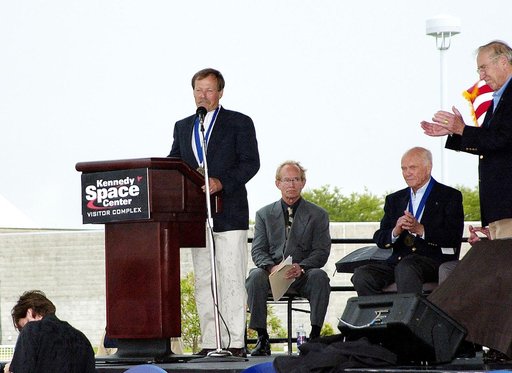 KENNEDY SPACE CENTER, FLA. -  At the KSC Visitor Complex, former astronaut Robert "Hoot" Gibson (at podium) addresses the audience at his induction ceremony into the U.S. Astronaut Hall of Fame. Also standing is former astronaut James A. Lovell.  Seated on the dais, from left, are actor and Master o