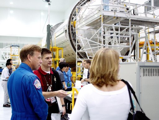 KENNEDY SPACE CENTER, FLA. -  NASA astronaut Steven W. Lindsey (left) listens to a briefing about the pressurized module of the Japanese Experiment Module (JEM) in the Space Station Processing Facility.  This major component of JEM, named "Kibo" (Hope), is Japan's primary contribution to the Interna