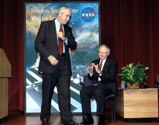 KENNEDY SPACE CENTER, FLA. -  NASA Administrator Sean O'Keefe (left) receives the applause of KSC Director Roy D. Bridges (right) and a group of KSC employees assembled in the KSC Training Auditorium.  The occasion is the announcement of James W. Kennedy as the next director of the NASA Kennedy Spac