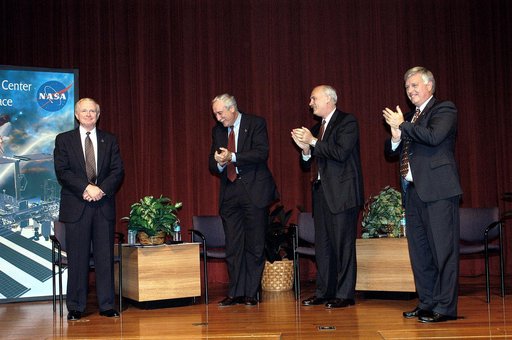 KENNEDY SPACE CENTER, FLA. -  KSC Center Director Roy D. Bridges receives the applause of NASA officials and a group of KSC employees assembled in the KSC Training Auditorium.   From left are Bridges, NASA Administrator Sean O'Keefe, NASA Associate Administrator of Space Flight William F. Readdy, an