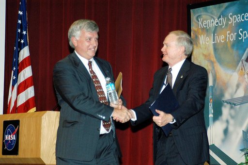 KENNEDY SPACE CENTER, FLA. -  KSC Deputy Director James W. Kennedy (left) and KSC Director Roy D. Bridges shake hands before a group of KSC employees assembled in the KSC Training Auditorium. The occasion is the announcement of Kennedy as the next director of the NASA Kennedy Space Center (KSC) in F