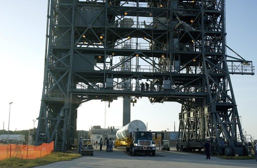 KENNEDY SPACE CENTER, FLA. -   On Launch Complex 17-B, Cape Canaveral Air Force Station, the first stage of a Delta II rocket arrives at the pad.  The rocket is being erected to launch the Space InfraRed Telescope Facility (SIRTF).  Consisting of an 0.85-meter telescope and three cryogenically coole