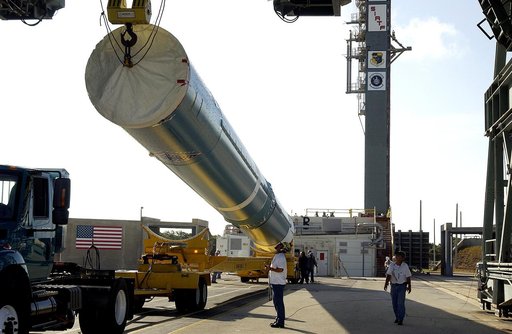 KENNEDY SPACE CENTER, FLA. -   On Launch Complex 17-B, Cape Canaveral Air Force Station, the first stage of a Delta II rocket is raised off the transporter before lifting and moving it into the mobile service tower.  The rocket is being erected to launch the Space InfraRed Telescope Facility (SIRTF)