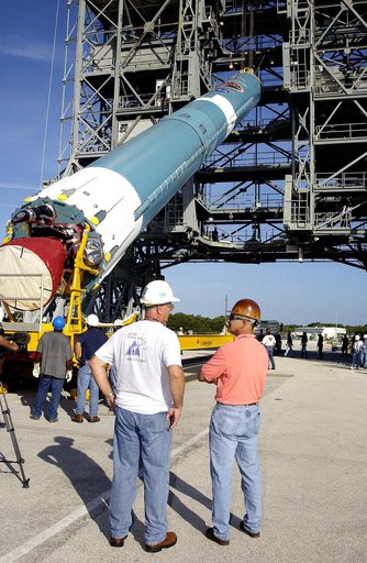 KENNEDY SPACE CENTER, FLA. -   On Launch Complex 17-B, Cape Canaveral Air Force Station, the first stage of a Delta II rocket is raised off the transporter before lifting it up and moved into the mobile service tower.  The rocket is being erected to launch the Space InfraRed Telescope Facility (SIRT