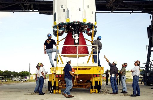 KENNEDY SPACE CENTER, FLA. -  Workers on Launch Complex 17-B, Cape Canaveral Air Force Station, prepare the first stage of a Delta II rocket for its lift up the mobile service tower.  The rocket is being erected to launch the Space InfraRed Telescope Facility (SIRTF).  Consisting of an 0.85-meter te