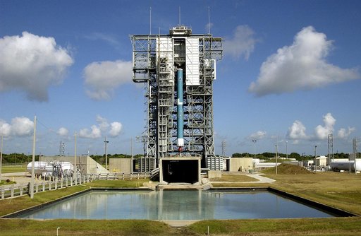 KENNEDY SPACE CENTER, FLA. -  On Launch Complex 17-B, Cape Canaveral Air Force Station, the first stage of a Delta II rocket is lifted up the mobile service tower.  Below the rocket is the flame trench, and in the foreground is the overflow pool.  The rocket is being erected to launch the Space Infr