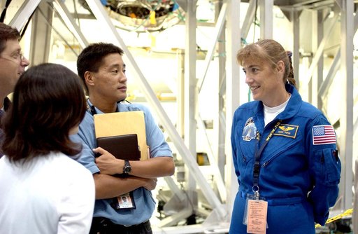KENNEDY SPACE CENTER, FLA. -  STS-115 Mission Specialist Heidemarie Stefanyshyn-Piper talks to workers in the Space Station Processing Facility.  She and other crew members are at KSC for hardware familiarization.  The mission will deliver the second port truss segment, the P3/P4 Truss, to attach to