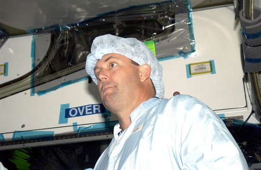KENNEDY SPACE CENTER, FLA. -   In the Space Station Processing Facility, STS-120 Mission Specialist Michael Foreman looks over the Japanese Experiment Module (JEM) Pressurized Module. Known as Kibo, the JEM consists of six components: two research facilities -- the Pressurized Module and Exposed Fac