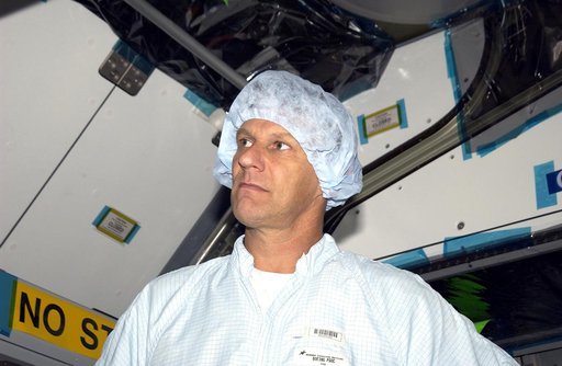 KENNEDY SPACE CENTER, FLA. -  In the Space Station Processing Facility, STS-120 Mission Specialist Piers Sellers looks over the Japanese Experiment Module (JEM) Pressurized Module. Known as Kibo, the JEM consists of six components: two research facilities -- the Pressurized Module and Exposed Facili